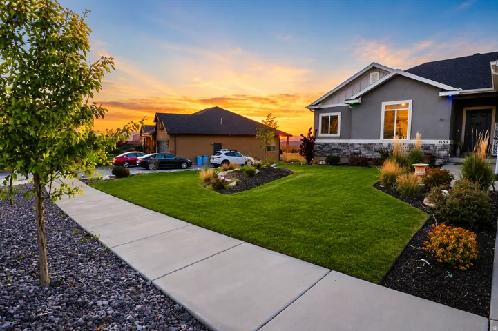 Contemporary exterior featuring a stucco finish, stone accent siding, and a dark shingle roof