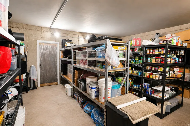 Concrete wall construction with overhead lighting, featuring a painted door frame