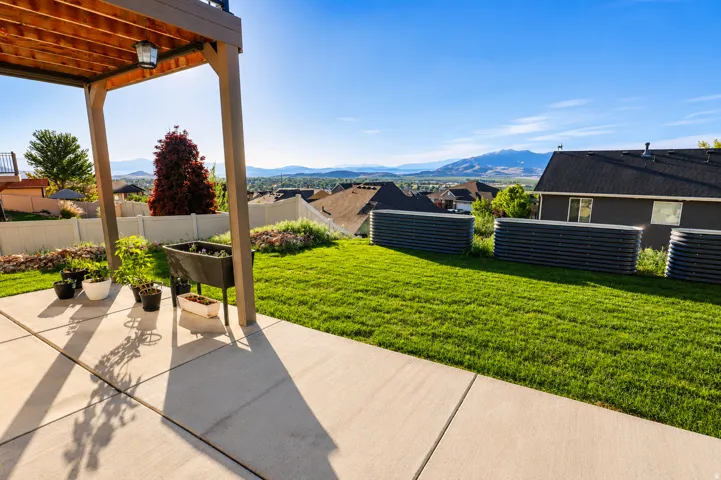 Concrete patio under a wood-paneled covered deck