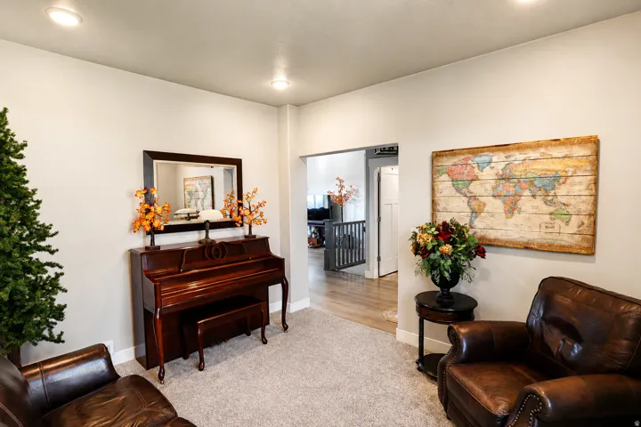 Open concept living space featuring recessed lighting, light neutral wall tones, and carpet flooring