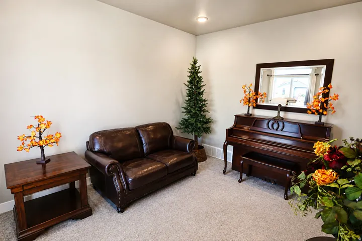 Neutral wall color with recessed lighting, complemented by light-toned carpet flooring