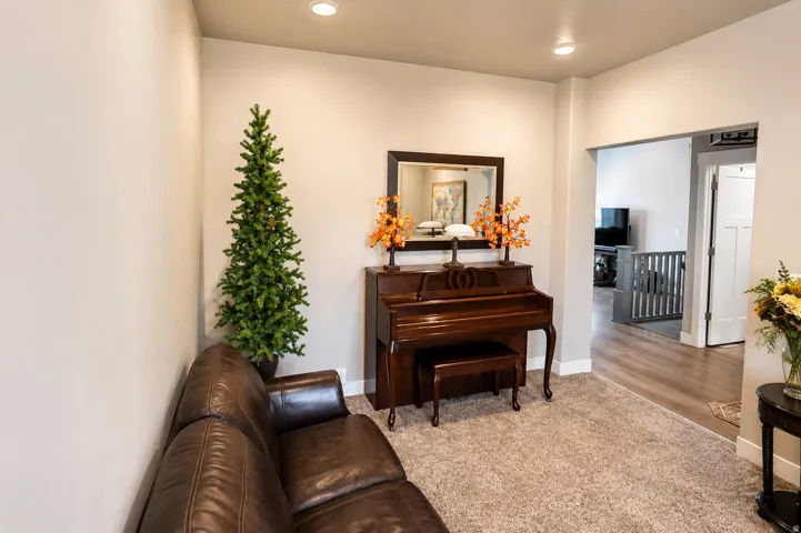 Carpeted flooring enhances a neutral-toned room with recessed lighting