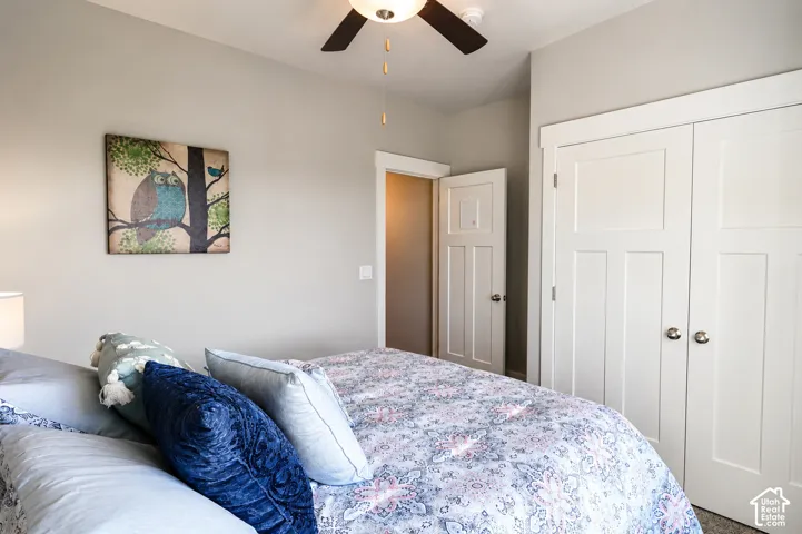 Bedroom featuring two white panel doors with brushed nickel hardware