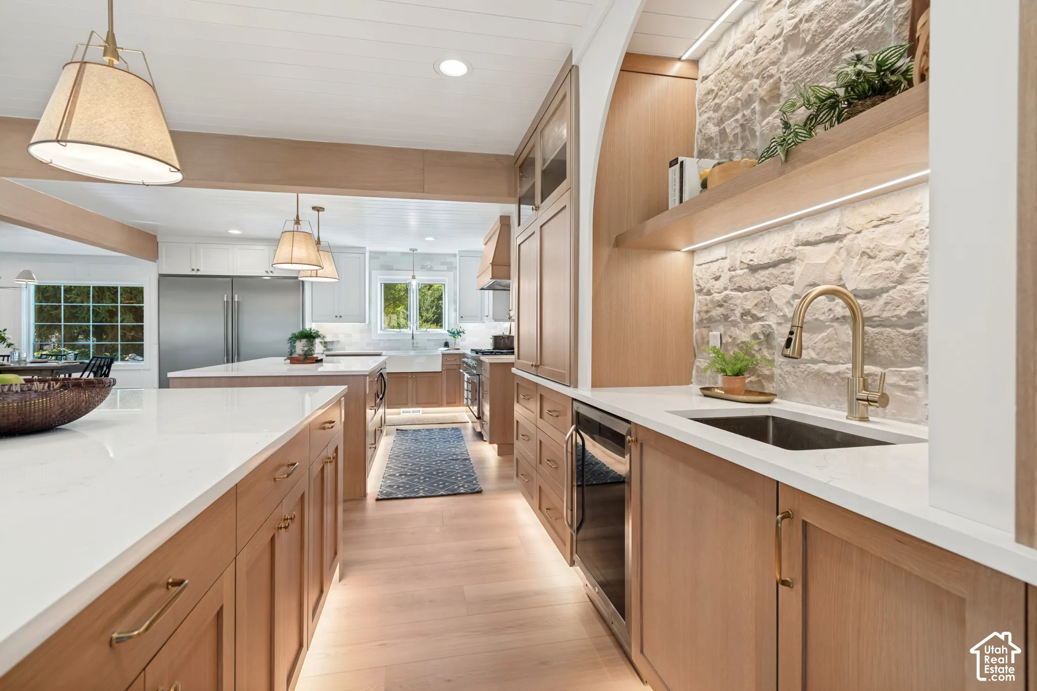 Contemporary kitchen featuring wood-finish cabinetry, white countertops, and wood-finish flooring