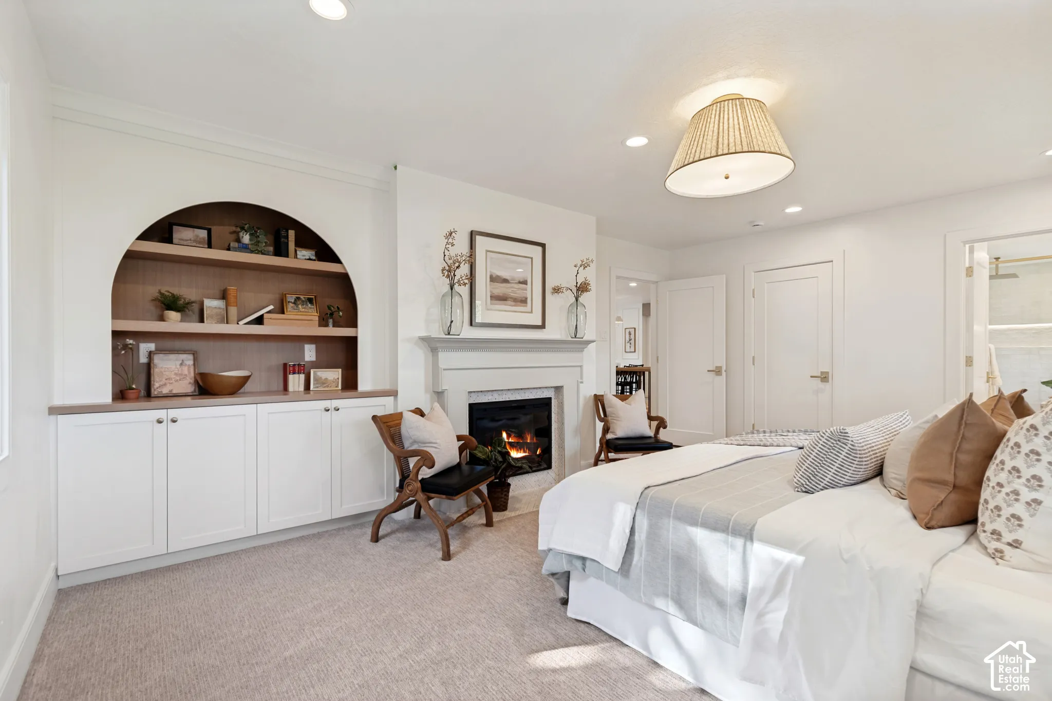 Built-in arched shelving with wood-finish backing and lower cabinetry