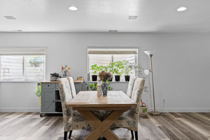 Spacious interior featuring wood-finish flooring and ample natural light from multiple windows