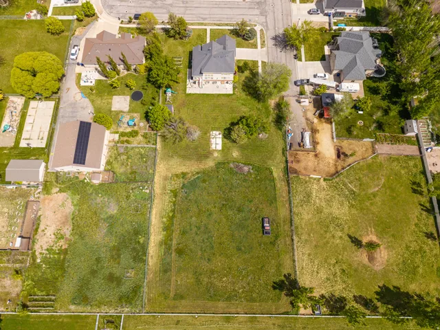 Expansive property featuring significant undeveloped land, multiple outbuildings, and a main residence with a substantial footprint