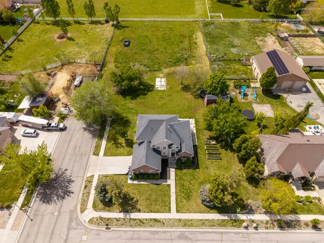 Two-story residence featuring a gray shingle roof and brick facade accents