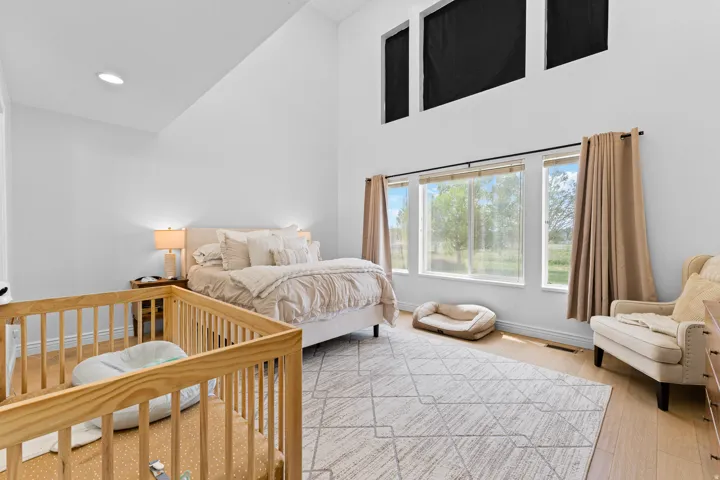 Bedroom with high vaulted ceilings and recessed lighting