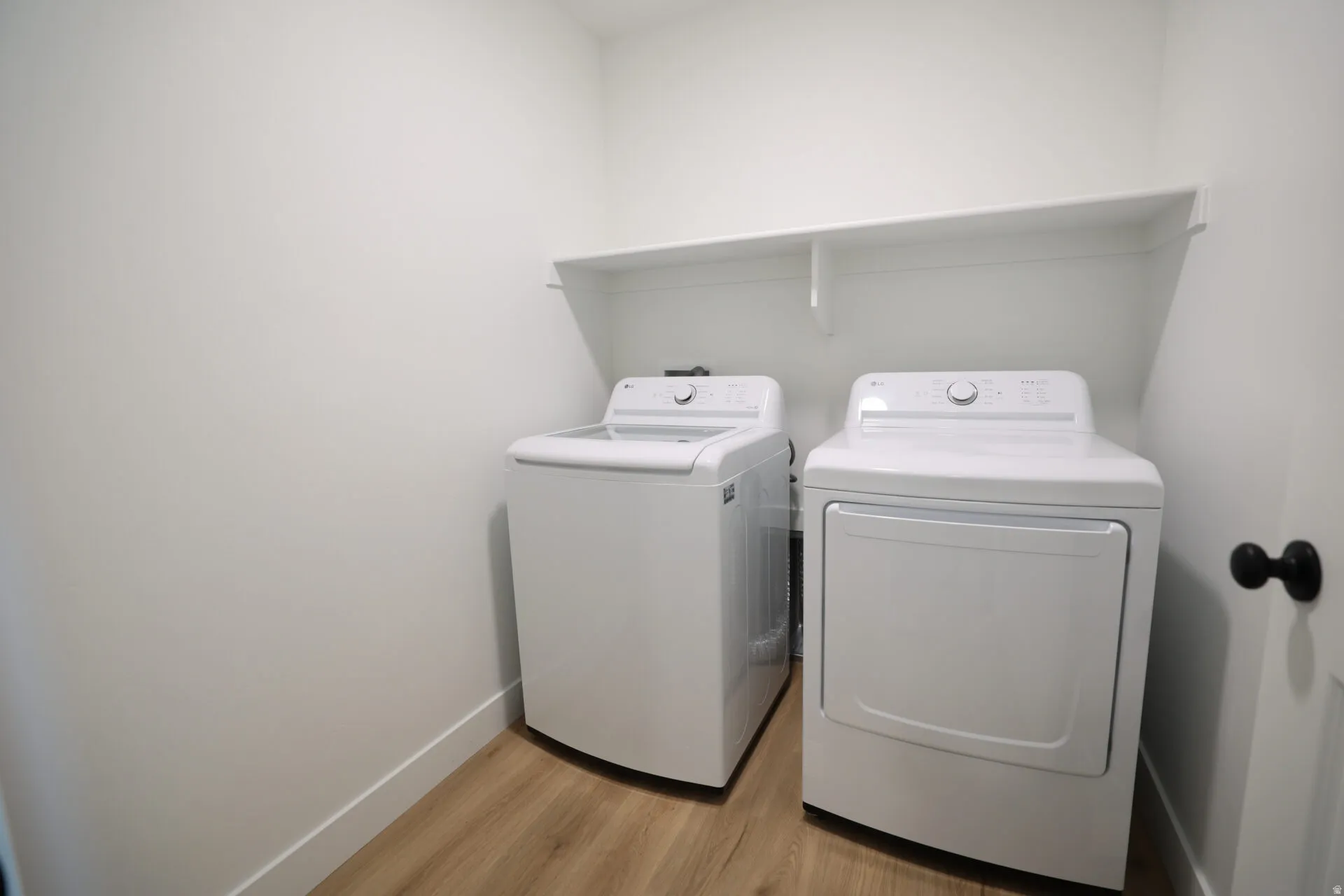 Dedicated laundry area featuring a white top-load washer and a white front-load dryer