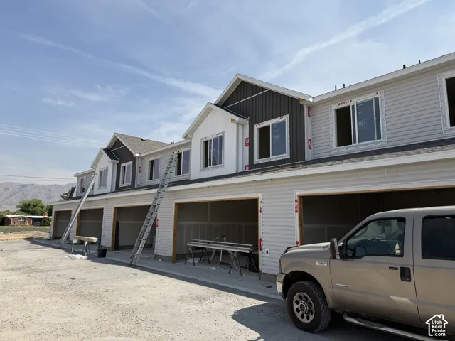 New construction townhomes featuring multi-tone siding and attached garages