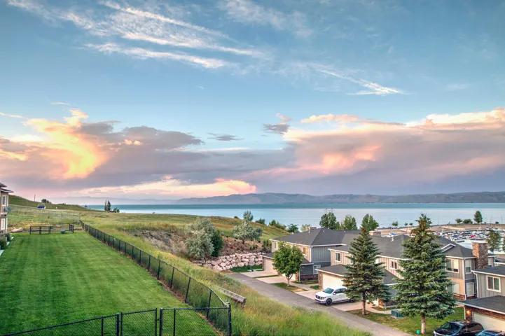 Expansive water body and distant mountains provide a picturesque backdrop to this property