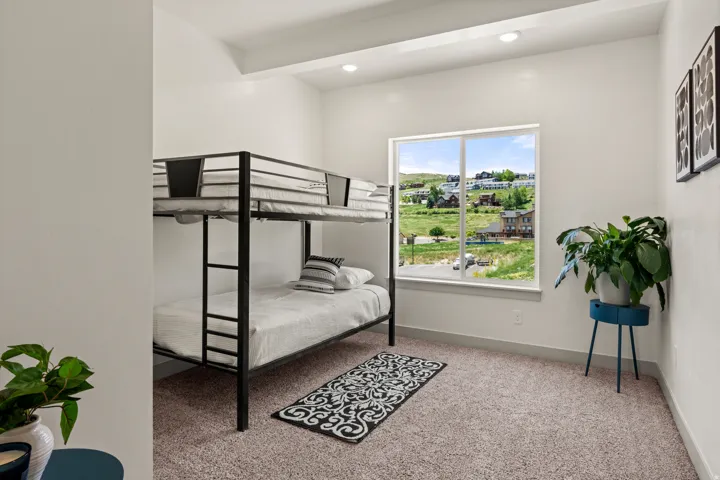 Bright room featuring a large window, recessed lighting, and soft carpet flooring
