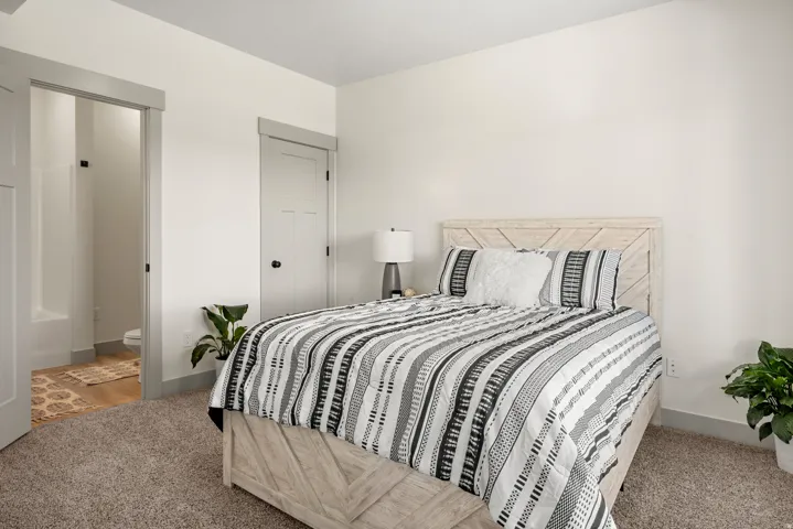 Spacious room featuring neutral carpeting, light-toned walls, and modern trimwork