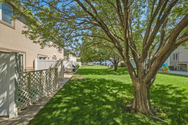 Expansive green lawn featuring mature trees