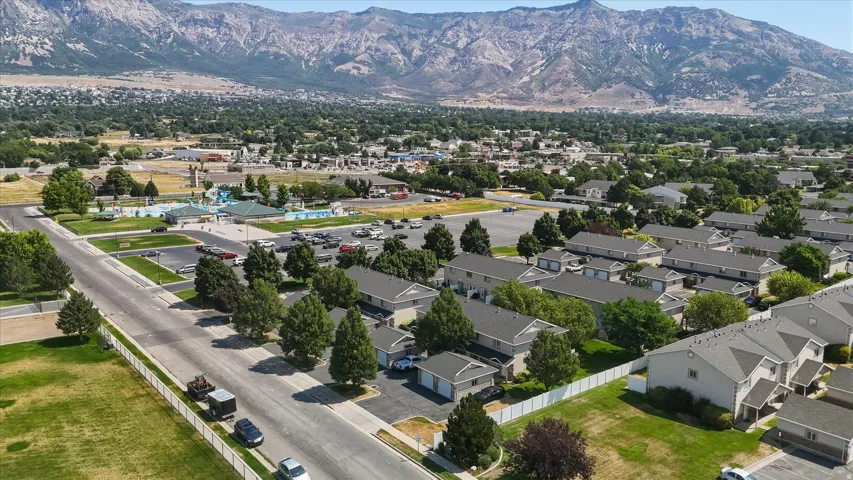 Townhome community featuring neutral-toned siding, dark roofing, and attached garages