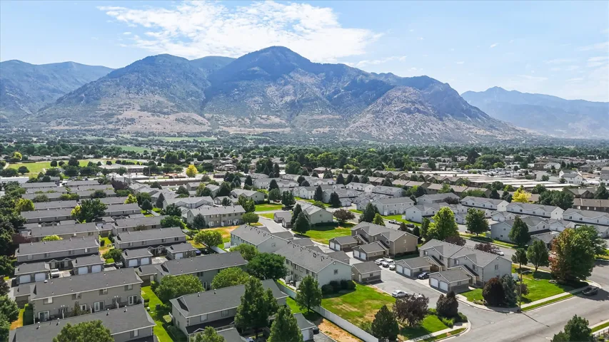 Community residences with mountain backdrop, offering green spaces and paved roadways