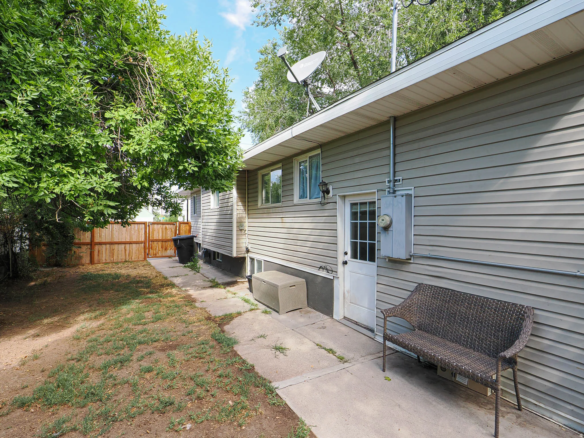 Exterior featuring horizontal siding, multiple windows, and a private rear entry door