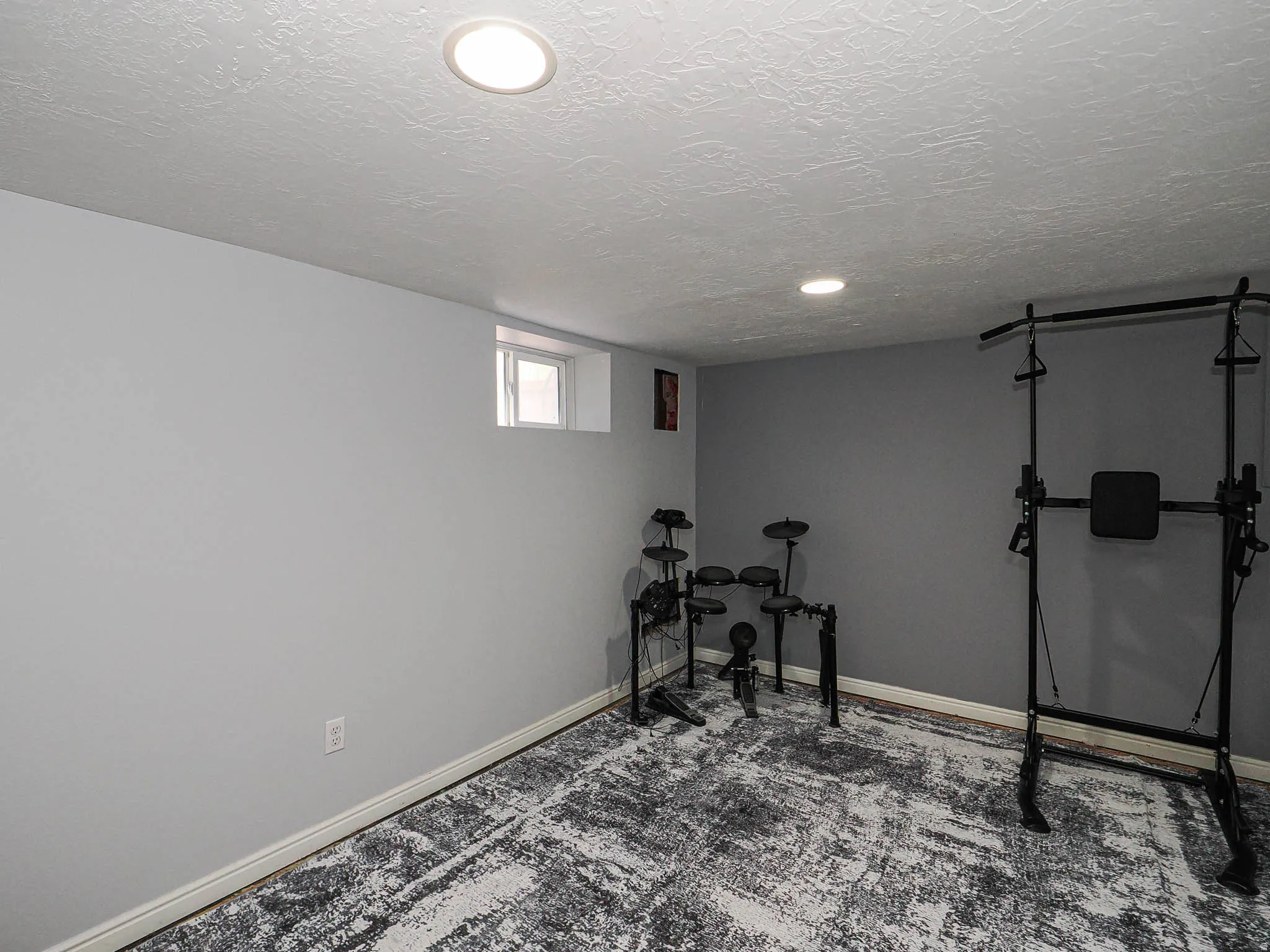 Room featuring light grey painted walls and a dark grey accent wall