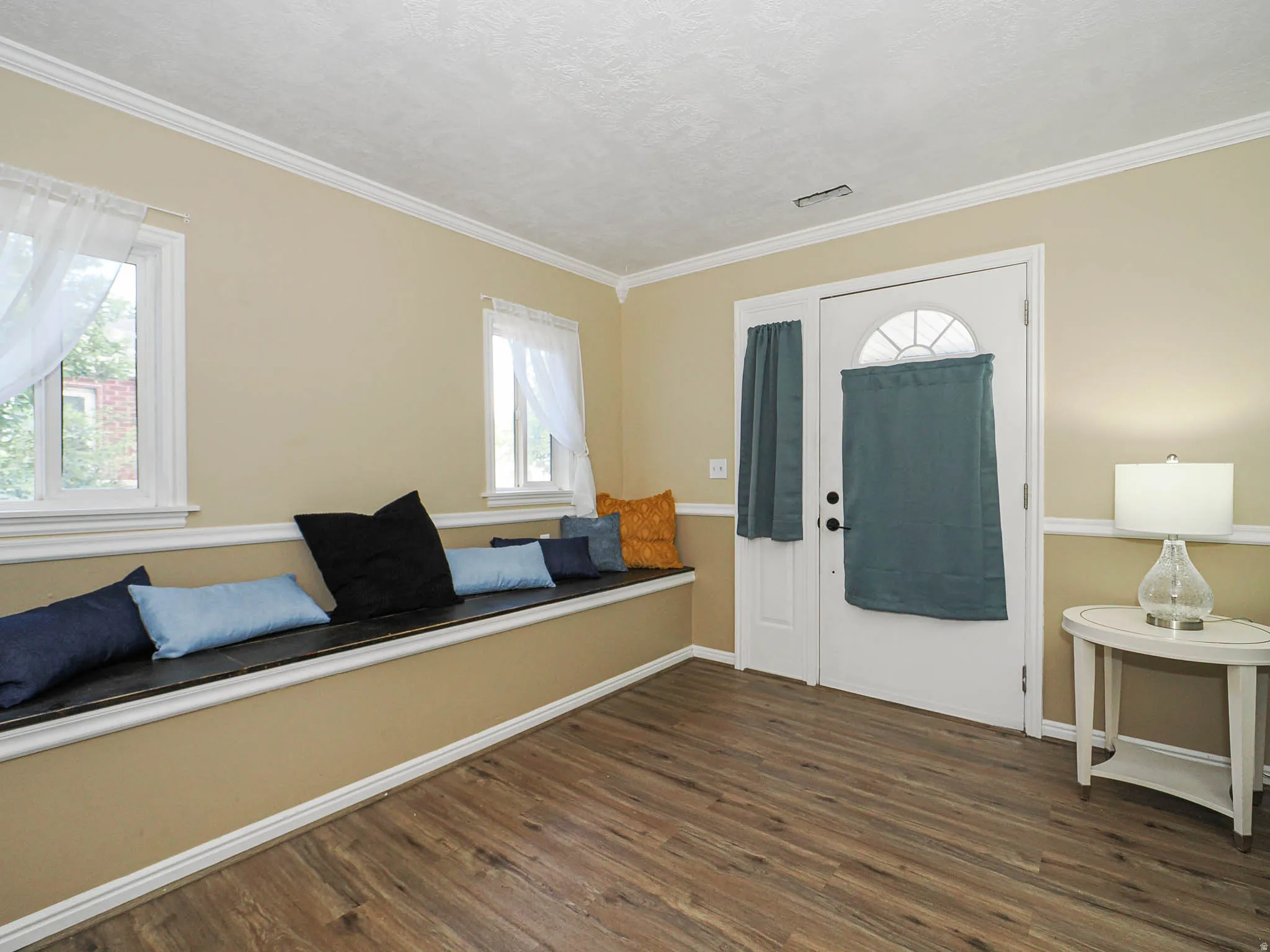 Entryway featuring wood-finish flooring and a built-in window seat