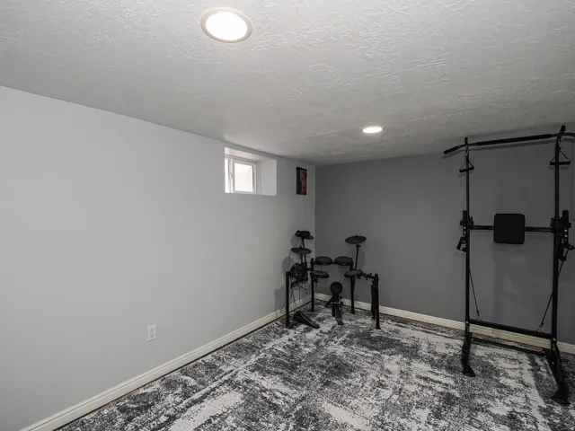 Room featuring light grey painted walls and a dark grey accent wall