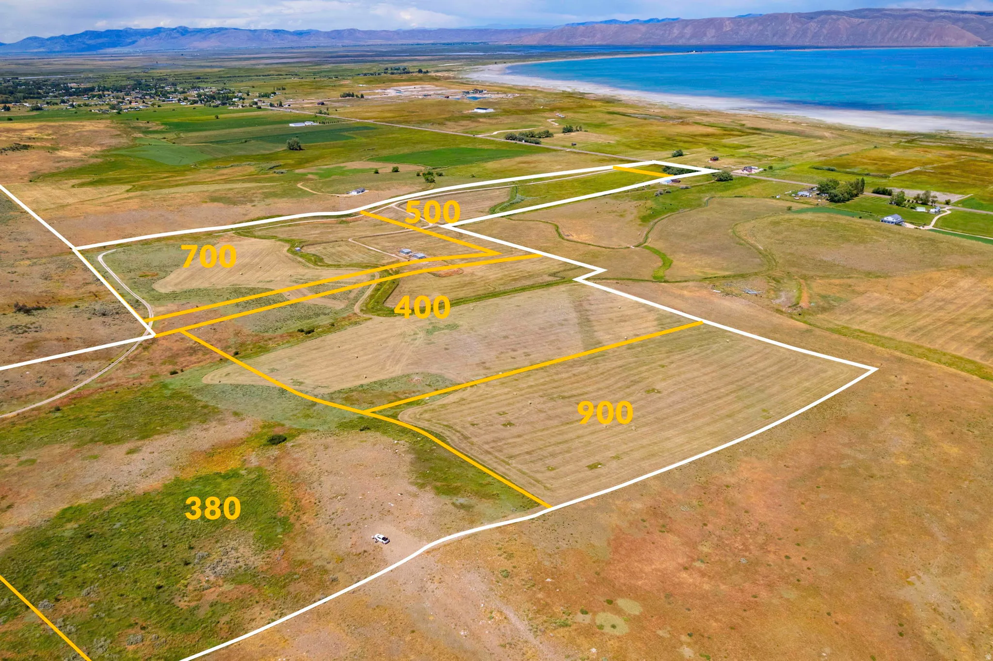 Expansive land parcels outlined with clear boundaries, featuring varied terrain from cultivated fields to natural vegetation
