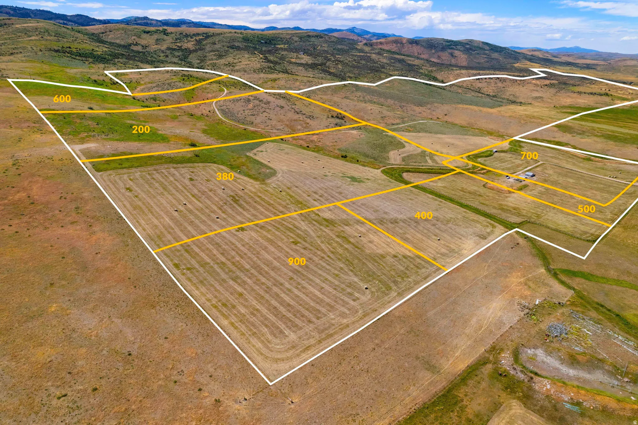 Expansive land parcels outlined with boundaries, featuring a mix of cultivated fields and undeveloped terrain