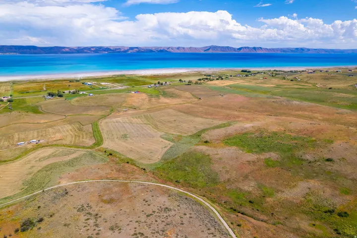 Expansive land parcel featuring natural topography, mixed vegetation, and a winding dirt path