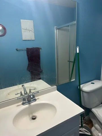 White vanity featuring an integrated sink with chrome faucet