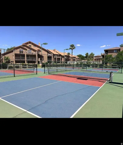 Multiple outdoor sport courts featuring blue, red, and green surfacing