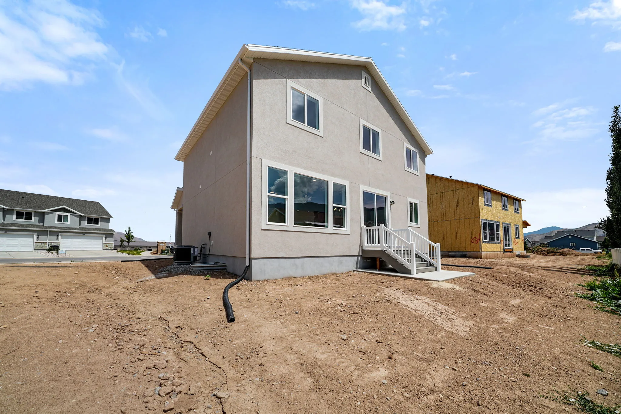 Contemporary two-story residence with a light-colored stucco exterior