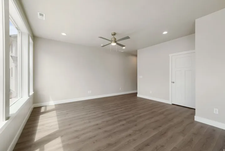 Spacious interior featuring a vaulted ceiling with a ceiling fan and recessed lighting