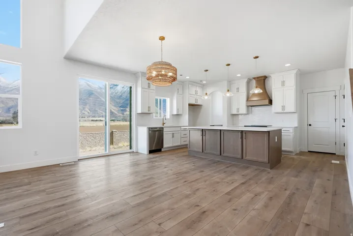 Open concept living space featuring wood-finish flooring and high ceilings