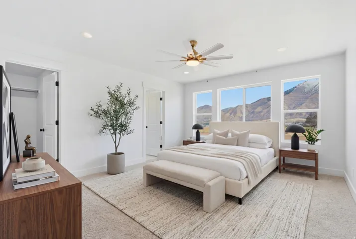 Bedroom featuring a large window array, recessed lighting, and a ceiling fan with integrated light