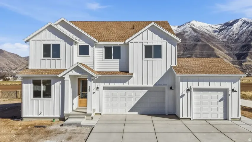 Modern Farmhouse exterior with white board and batten siding and a brown shingle roof