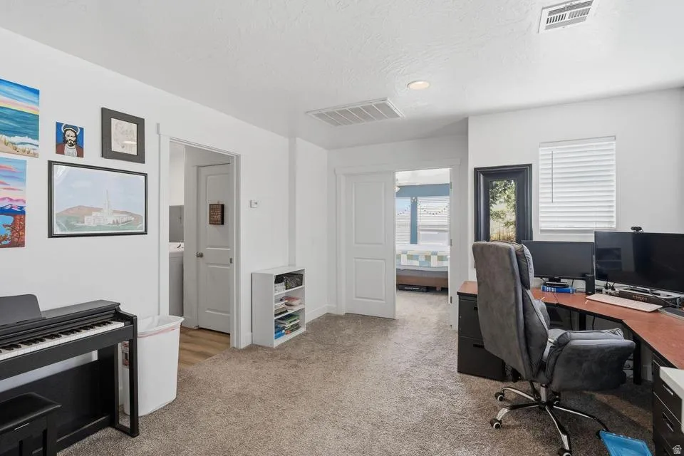 Carpeted room featuring white walls and a white ceiling with recessed lighting