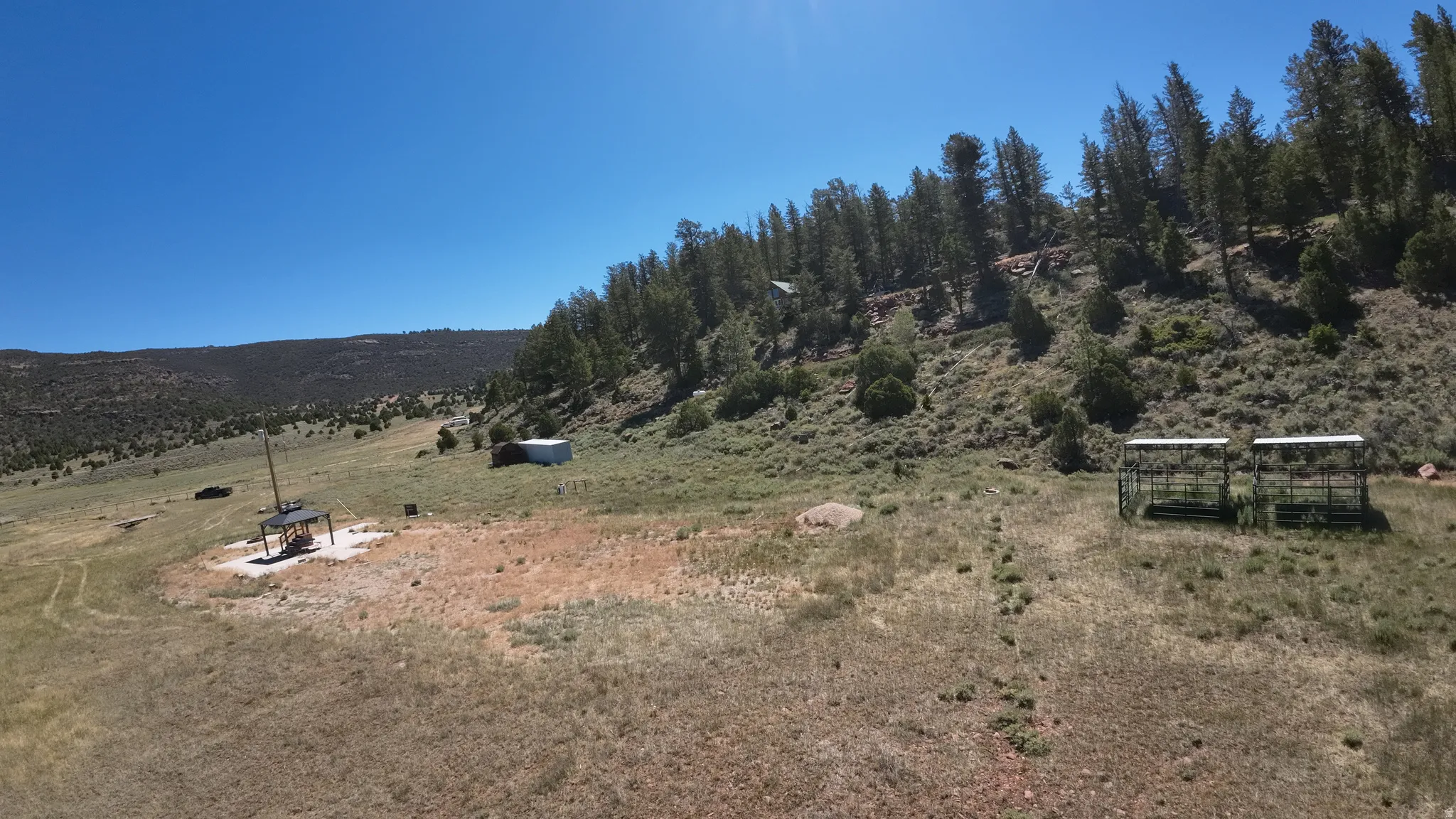 Expansive natural landscape featuring rolling hills and abundant trees