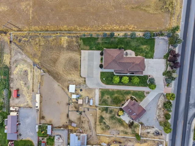 Aerial perspective showcasing a primary residence with a detached auxiliary building