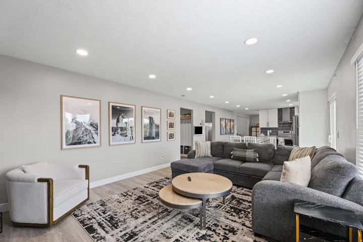 Open-concept living area featuring recessed lighting, light wood-finish flooring, and a neutral wall palette