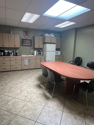 Tiled flooring throughout this space, featuring ample cabinetry with a light wood finish and a recessed ceiling with integrated lighting