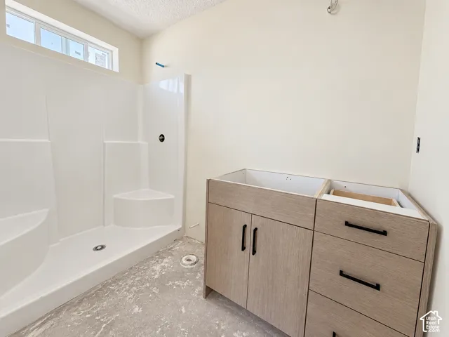 White shower enclosure with integrated seating-under construction