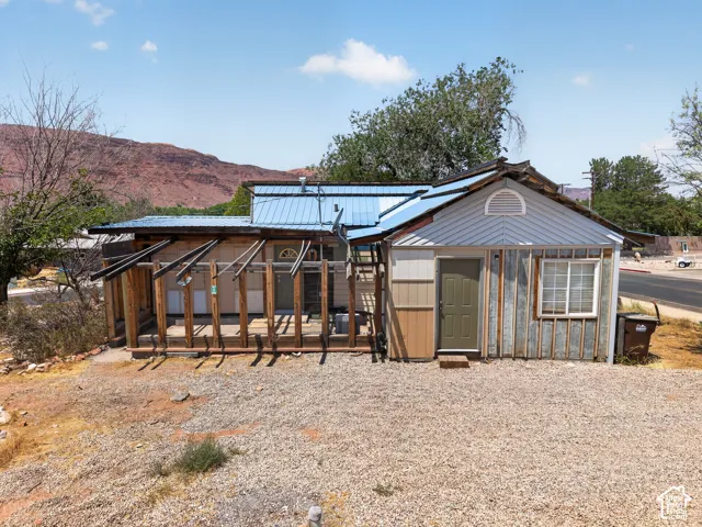 Property exterior featuring multiple siding types and a blue metal roof