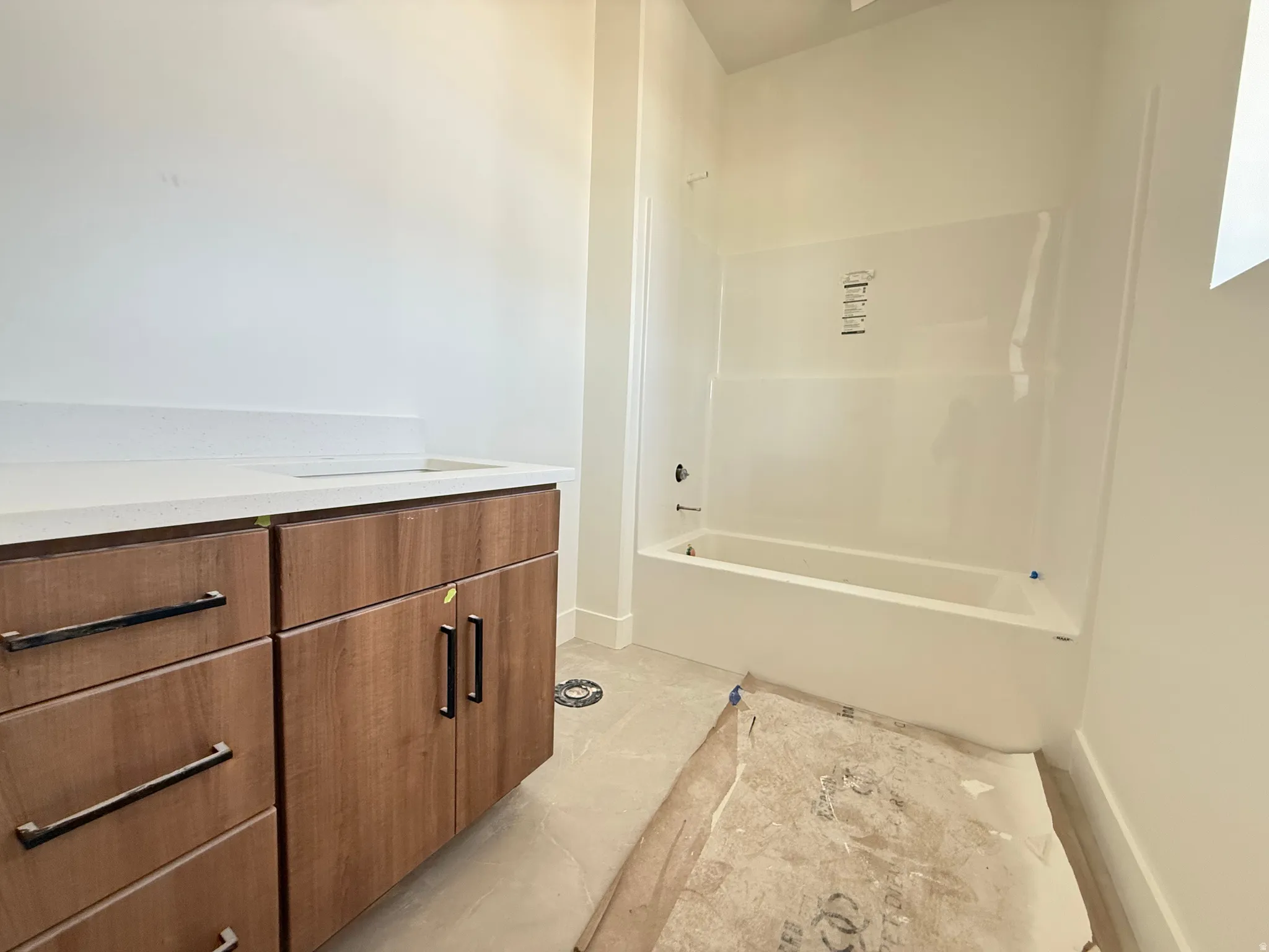 White bathtub and shower surround with visible faucet fixtures