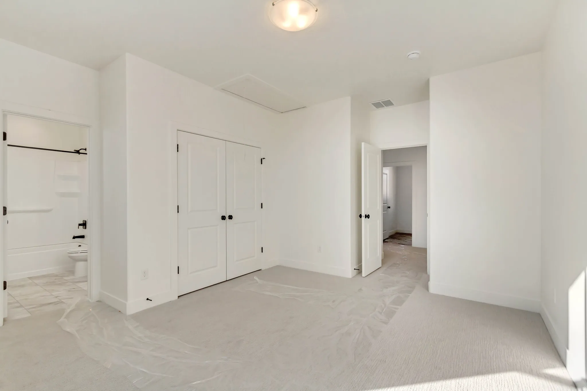 Secondary bedroom: featuring attic space for plenty of storage and a bathroom.