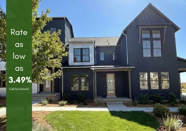 Contemporary exterior with dark siding, white trim accents, and multiple large windows