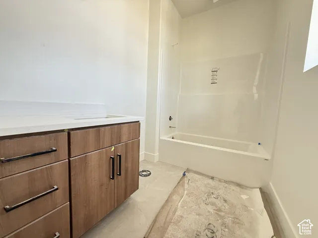 White bathtub and shower surround with visible faucet fixtures