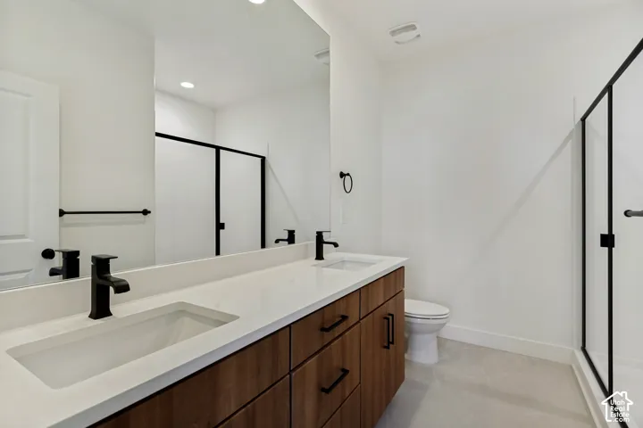 Wood-finish dual-sink vanity with a quartz countertop, matte black fixtures, full-width mirror, and walk-in shower with a matte black frame