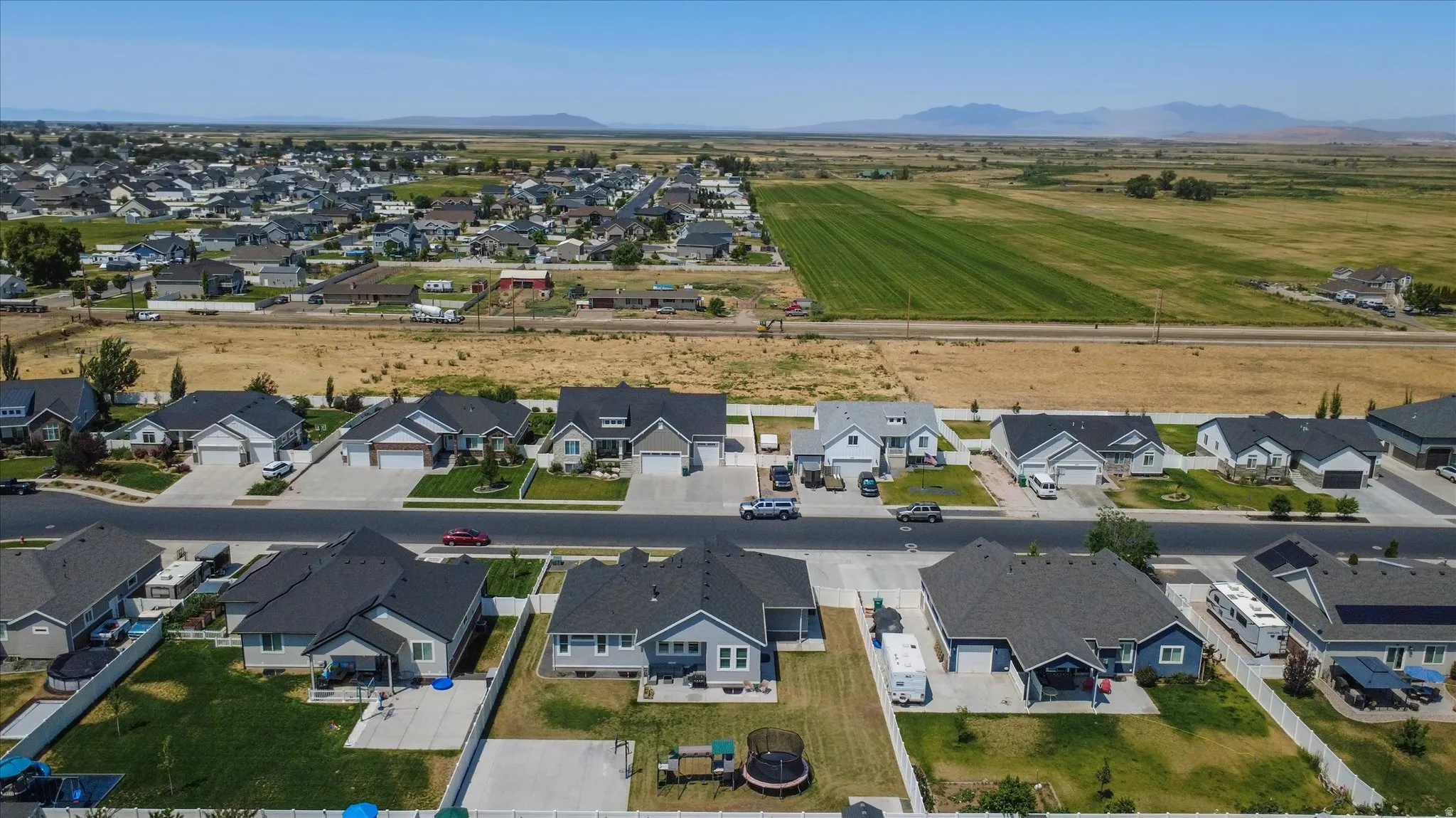 New construction residential area featuring single-story homes with dark shingle roofs
