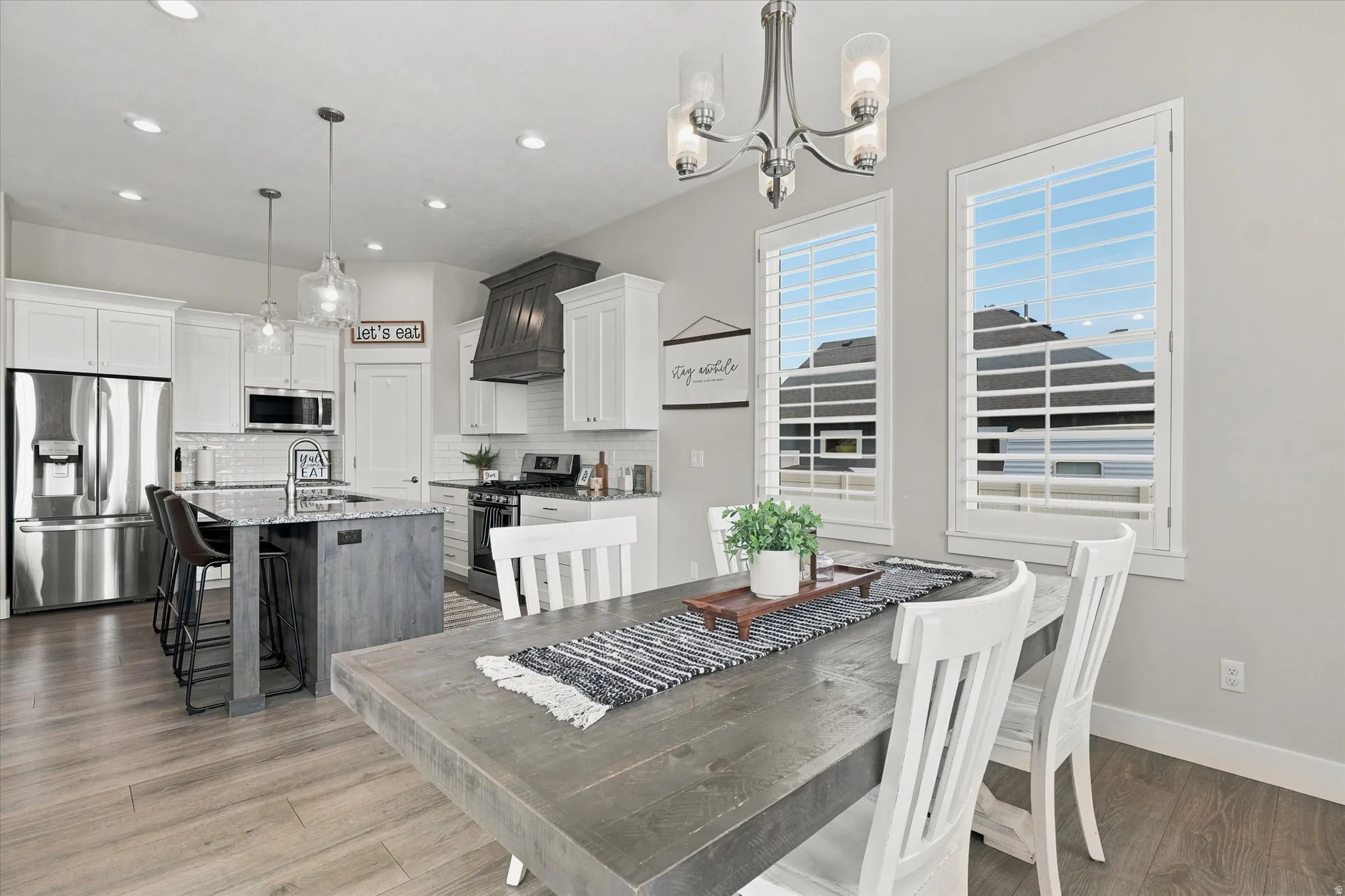 Open-concept kitchen and dining area featuring wood-finish flooring