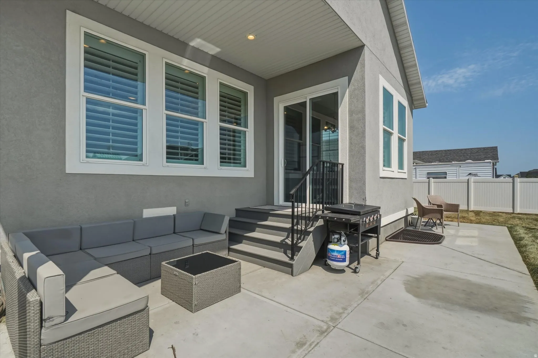 Covered concrete patio featuring recessed lighting